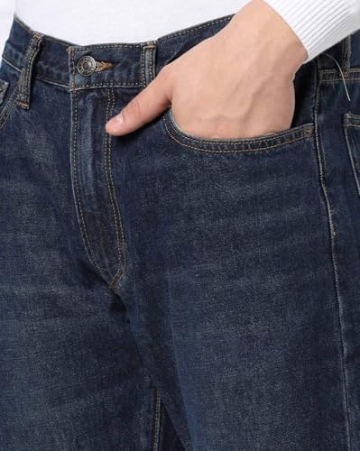 Gap men's dark washed straight fit stretchable jeans with mid-rise, shown on a model, highlighting their fit and fabric texture.