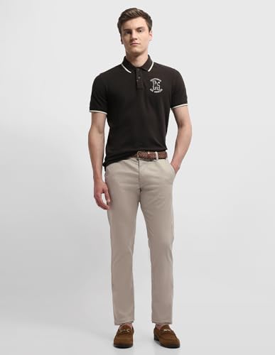 Arrow Sport men's Bronson slim fit chino pants in casual tan color, featuring a modern art-inspired design on the fabric.