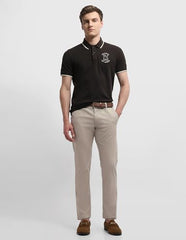 Arrow Sport men's Bronson slim fit chino pants in casual tan color, featuring a modern art-inspired design on the fabric.