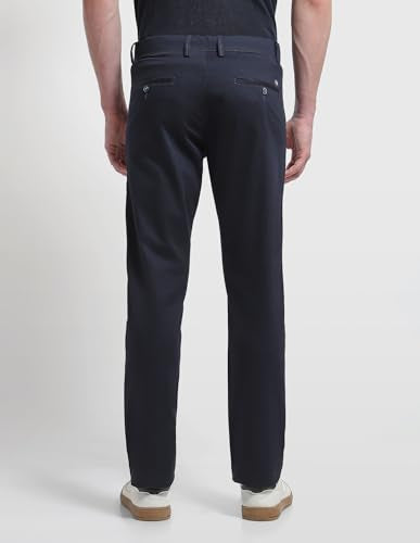 Arrow Sport men's solid Bronson slim fit casual trousers, showing navy blue fabric, front pockets, and tailored slim silhouette.