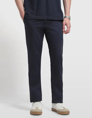 Arrow Sport men's solid Bronson slim fit casual trousers, featuring a sleek design and tailored fit in a neutral color.