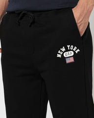Black men's Gap regular fit mid-rise joggers with elastic waistband and pockets, suitable for casual sportswear.