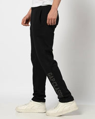 Men's Gap logo print mid-rise track pants in sportswear, featuring a relaxed fit and casual style.