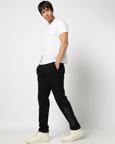 Men's Gap logo print mid-rise track pants with elastic waistband and sporty design, perfect for casual or athletic wear.