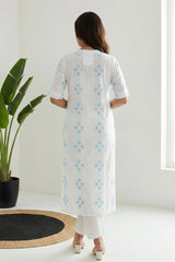 Aurelia ladies western kurti in vibrant fabric, displayed on a hanger with intricate design details and bright colors.