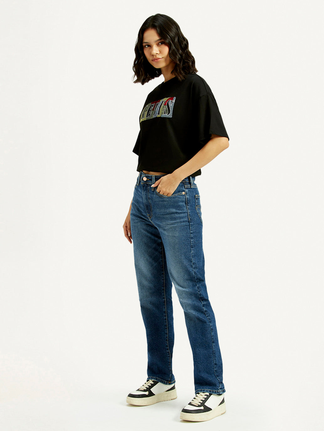 Levi's women's blue wedgie straight fit mid-rise jeans shown from the side with classic denim look.