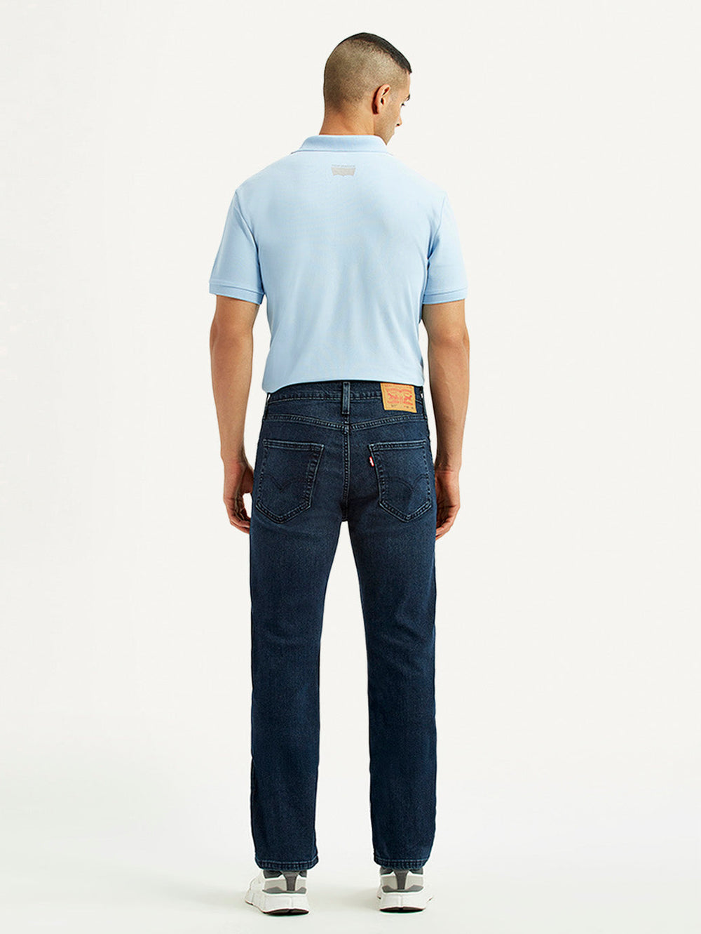 Back view of Levi's men's jeans in dark wash, featuring classic five-pocket design and straight-leg fit.