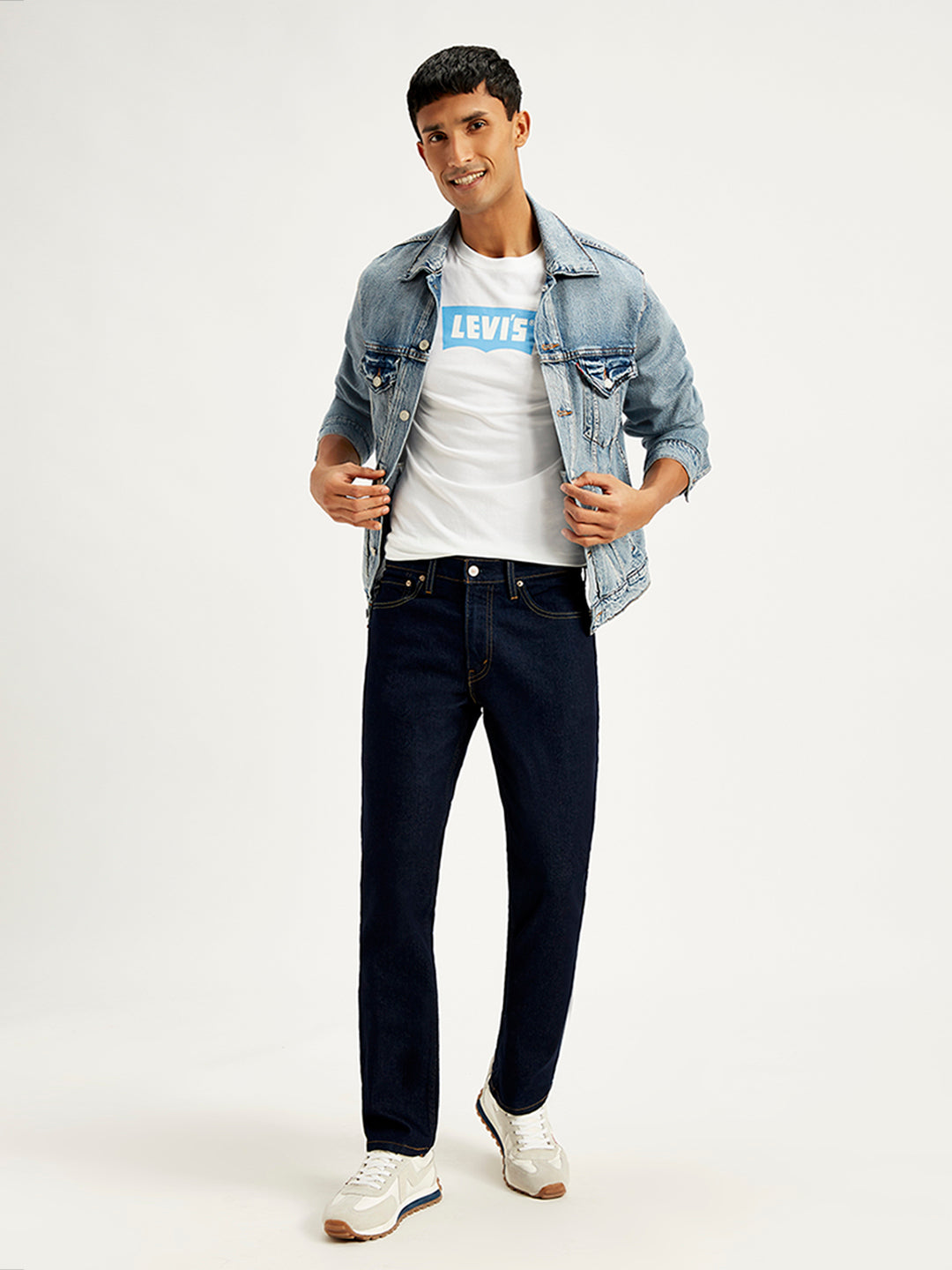 Levi's men's 511 blue slim fit mid-rise jeans displayed on a model in a style shot.