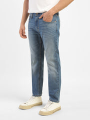Levi's men's blue slim tapered fit mid-rise jeans shown from a side view, showcasing the classic denim style and fit.