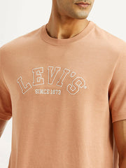 Levi's men's embroidered peach crew neck T-shirt with detailed embroidery, short sleeve, casual style, on a plain background.
