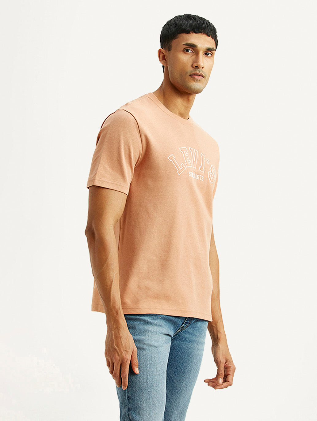 Levi's men's embroidered peach crew neck T-shirt with short sleeves, displayed from a side view showing embroidery details.