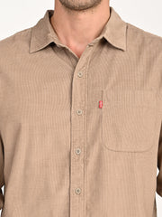 Levis men's beige slim fit corduroy casual shirt with collar and button details, displayed on a hanger.