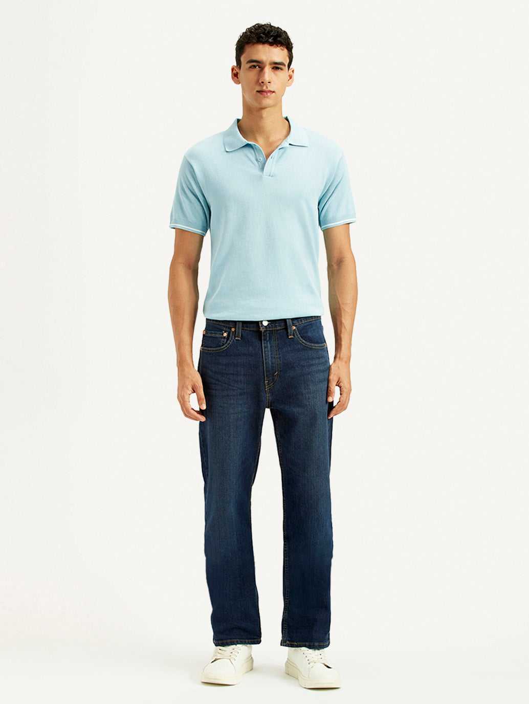 Levis men's jeans in classic blue denim with a straight fit, shown folded with visible stitching and five-pocket design.