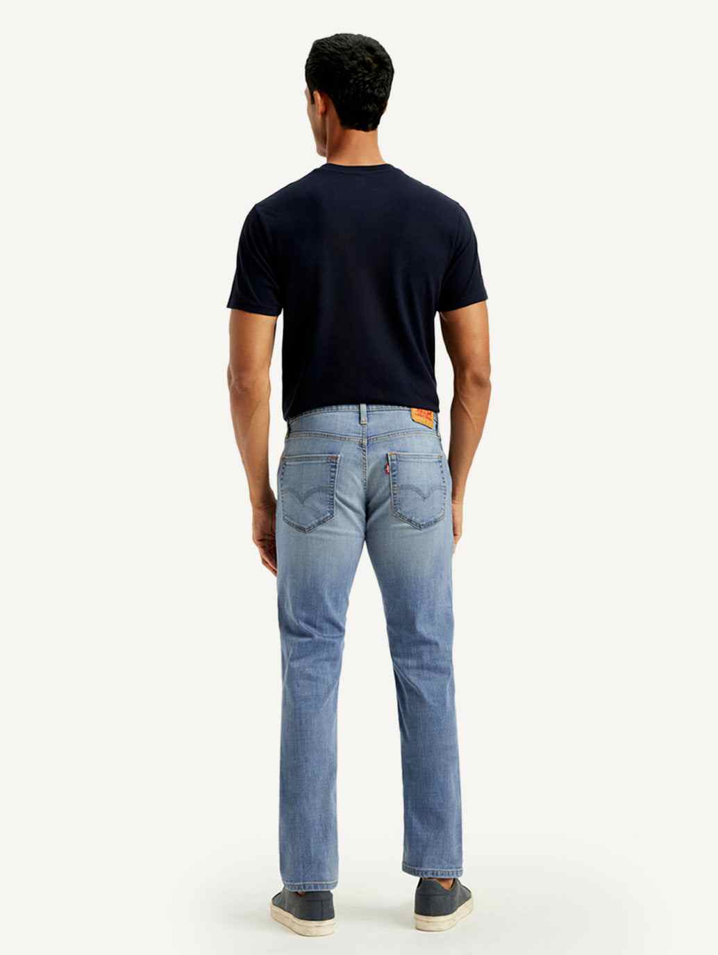 Light blue Levi's men's slim fit mid-rise 511 jeans displayed on a model, showcasing the stylish, modern denim fit.