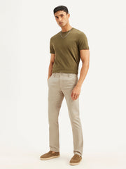 Men's beige slim fit chinos by Levi's, casual men's lower trouser with a tailored fit and classic style, shown on a model.